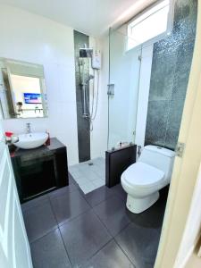 a bathroom with a toilet and a sink and a shower at Heartbeat Fall in Love in Sattahip