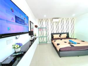 a bedroom with a bed and a flat screen tv at Heartbeat Fall in Love in Sattahip +43 photos