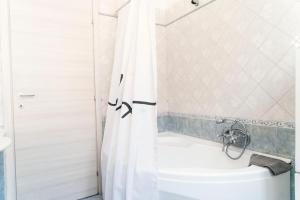 a bathroom with a white tub and a toilet at Cleo Viola in Ancona