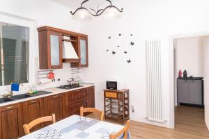a kitchen with a table and a dining room at Cleo Viola in Ancona