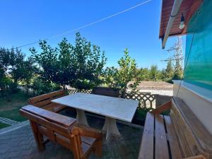 a picnic table and two benches on a patio at Onis Sea View Apartments in Orikum +28 photos