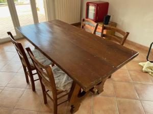 a wooden dining room table with chairs and a table at Da Vittoria in Albissola Marina +19 photos
