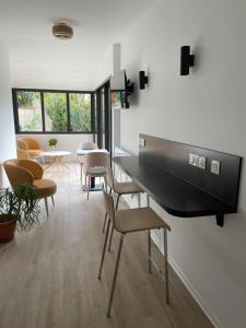 a living room with a table and chairs at H&ocirc;tel Pyr&egrave;ne in Foix