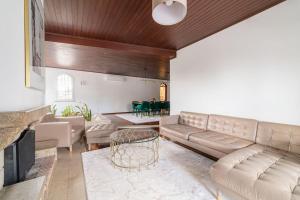 a living room with a couch and a table at Portuguese Luxury Villa in Setúbal