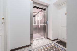 a hallway with a shower and a tile floor at Yoga Residence Apartments in Tallinn +86 photos