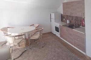 eine Küche mit Tisch und Stühlen in einem Zimmer in der Unterkunft Sušek in Glamoč