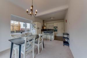a kitchen and dining room with a table and chairs at 2BR Detached Bungalow with Parking in Stannington