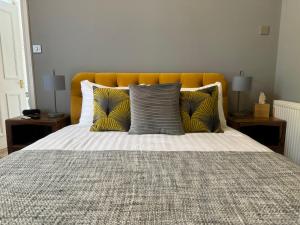 a bedroom with a large bed with pillows at The Red Lion Hotel in Cromer