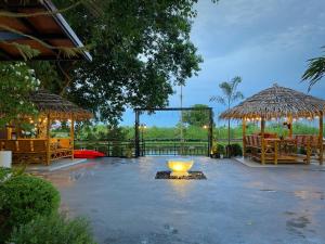 a patio with a large bowl in the middle at Anna River Home A2 in Ban Khlong Si