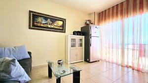 a living room with a couch and a refrigerator at Perla del Paraiso in Playa Paraiso