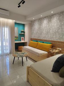 a living room with two beds and a table at Dina's House in Vonitsa +11 photos