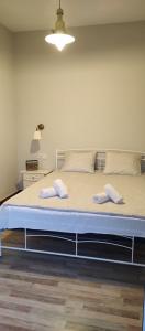 a bed in a room with two towels on it at My corfu house in Agios Stefanos
