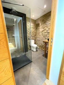 a bathroom with a glass shower and a toilet at Charmante Maison Rustique in Piriac-sur-Mer +17 photos
