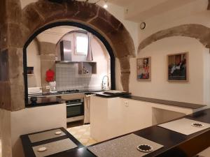 a large kitchen with an archway in a building at Studio avec terrasse in Crest