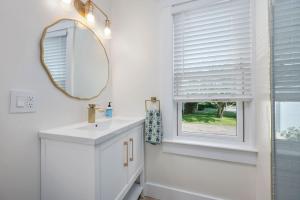 a bathroom with a sink and a mirror and a window at 232 Wood Road South Yarmouth - Cape State of Mind in South Yarmouth +37 photos