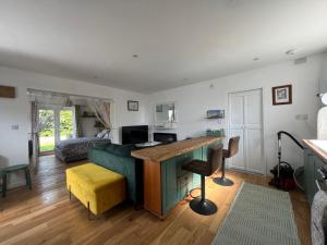 a living room with a couch and a desk at Ty Cariad in Saundersfoot