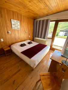 a bedroom with a bed and a desk and a window at Le Terril Blanc in Tignes