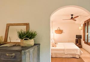 a bedroom with a bed and a mirror at La Lolita ( Adults Only ) in Sant Mart&iacute; Vell