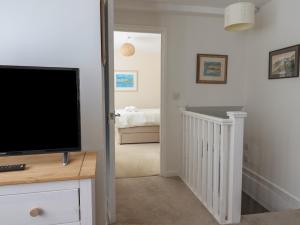 a living room with a flat screen tv on a dresser at 16 Church Street in Lyme Regis