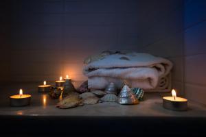 a group of candles sitting next to a pile of towels at Amalfi Luxury House in Amalfi