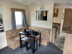 a living room with a couch and a table at J06 Warren Retreat in Dawlish Warren