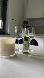 a bottle of wine sitting on a table with two glasses at Ferienwohnung an der Wildenburg in Kempfeld +7 photos