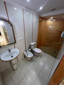 a bathroom with two toilets and a sink and a shower at Appartement RITZ in Tangier +26 photos