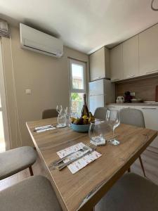 a wooden table in a kitchen with wine glasses at Comfy home 2 - Burgas Centre in Burgas City