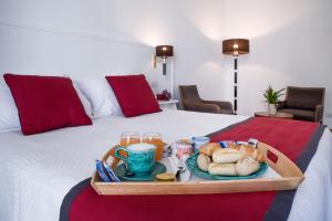 a tray of breakfast food on a bed at Amalfi Luxury House in Amalfi