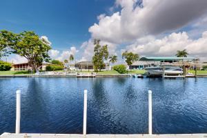 a large body of water with a house in the background at Modern Getaway in Cape Coral