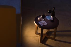 a small table with two glasses of wine on it at Amalfi Luxury House in Amalfi