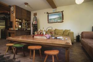 a living room with a wooden table and stools at Guesthouse Šejn in Kopaonik
