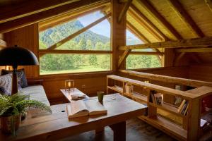 a room with a wooden table with a book on it at Chalet La Chandelle - OVO Network in Bionnassay