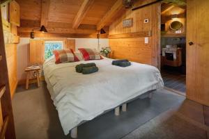 a bedroom with a large bed in a cabin at Chalet La Chandelle - OVO Network in Bionnassay +23 photos