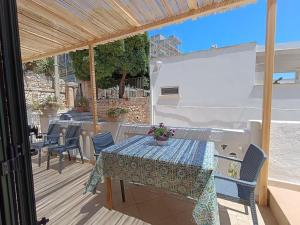 a patio with a table and chairs on a deck at Adelè posto tranquillo al centro del paese in Santa Cesarea Terme