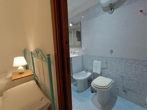 a bathroom with a white toilet and a sink at Adelè posto tranquillo al centro del paese in Santa Cesarea Terme +83 photos
