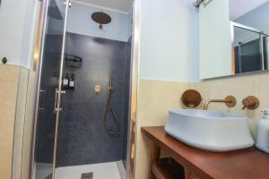 a bathroom with a sink and a shower at Loft57 L&G - Centro storico in Bari +17 photos