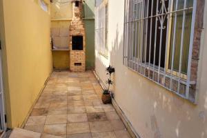 um corredor vazio em um prédio antigo com piso de ladrilho em Casa em Cabo Frio próximo à praia - Mar e Sol em Cabo Frio