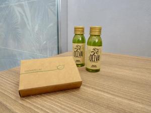 two bottles of vinegar and a box on a table at Il Fico Lake Iseo b&b in Iseo