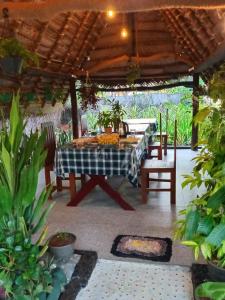 a patio with a table and chairs under a pergola at Lake Face Cabana in Tissamaharama