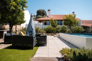 a backyard with a swimming pool and a house at Casa dos Escritores - Casa de Férias com Piscina Privada in Marvão