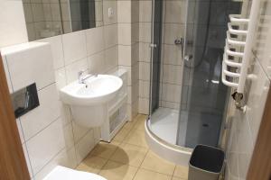 a bathroom with a sink and a shower at Albatros in Gąski +93 photos