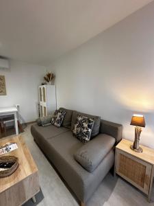a living room with a couch and a table at Appartement "La Rose des Vents" in Saintes-Maries-de-la-Mer