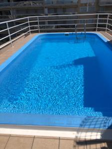 a large blue swimming pool with blue water at Diplomatic Salou in Salou