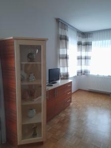 a living room with a cabinet with a television on it at Romy in Deutschlandsberg