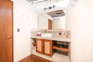 a bathroom with a sink and a mirror at Welcome to Paradise - Luxurious Studio Oasis "Urania" with Pool and Lush Tropical Gardens in Sayulita +13 photos