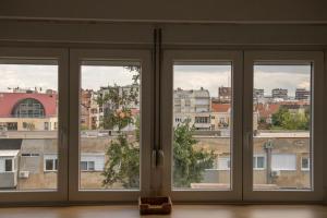 Habitación con 3 ventanas con vistas a la ciudad en Apartment Ivon, en Belgrado