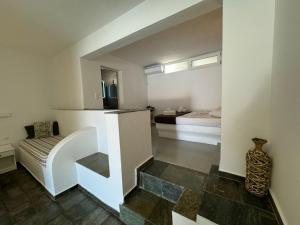 a living room with a stairs leading to a bedroom at Ergina Studios in Ios Chora +175 photos