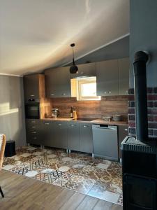 a kitchen with stainless steel cabinets and a stove at Apartment Šušanj in Bar