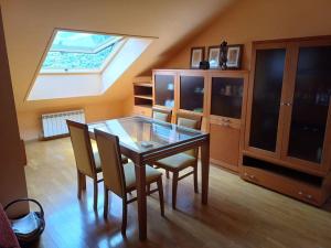 a dining room with a glass table and chairs at La Tebaida in Ponferrada